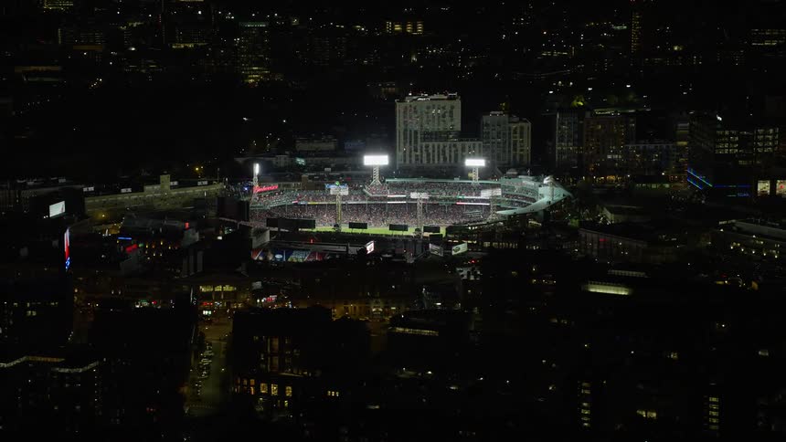 Aerial view of a baseball stadium in the city at night