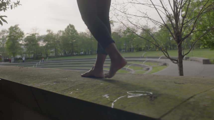 A person is walking on the top of a wall