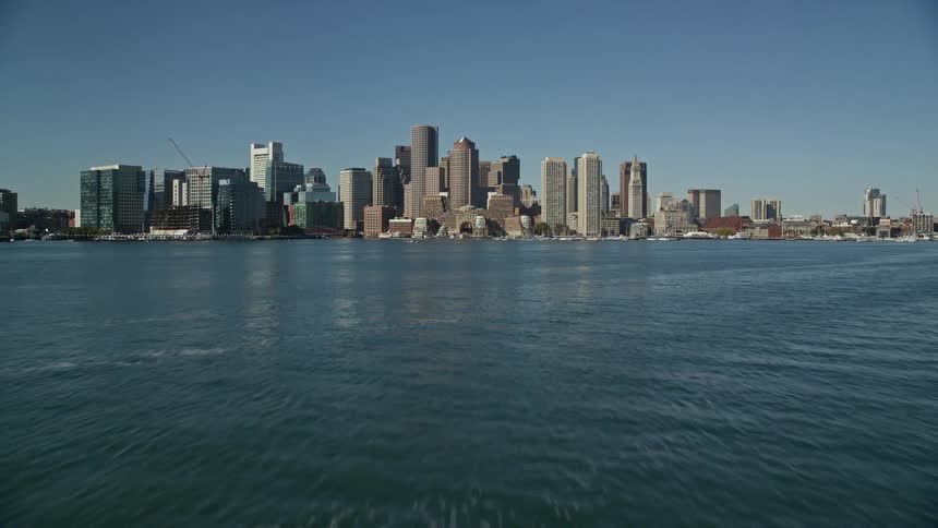 A metropolitan city with huge buildings facing the ocean