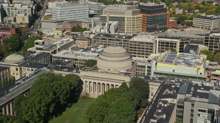 Aerial panorama of a city with a focus on a public building with a central dome