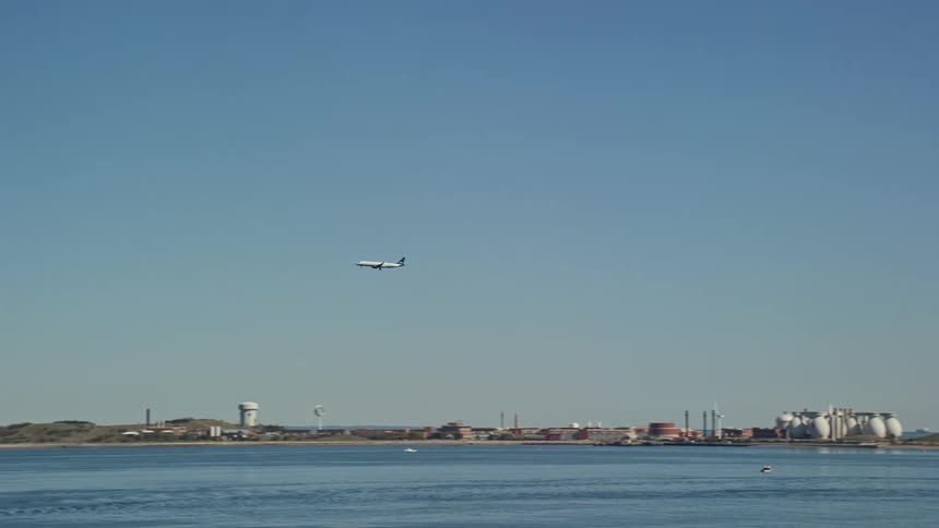 Airplane landing over the sea