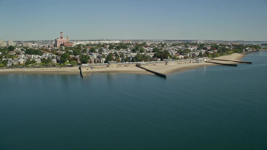 Homes are lined up against the beach in the suburbs