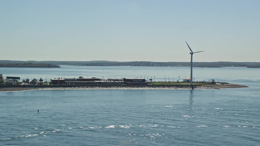 A small island with a windmill on the sea coast