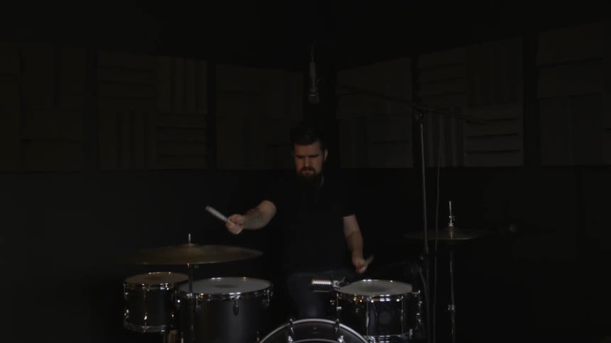 A man is playing drums