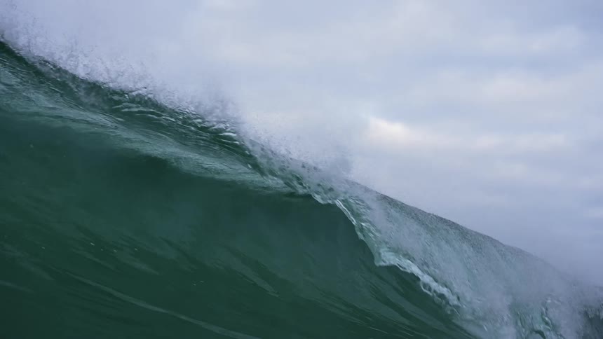 Panorama of a sea wave forming and breaking in slow motion