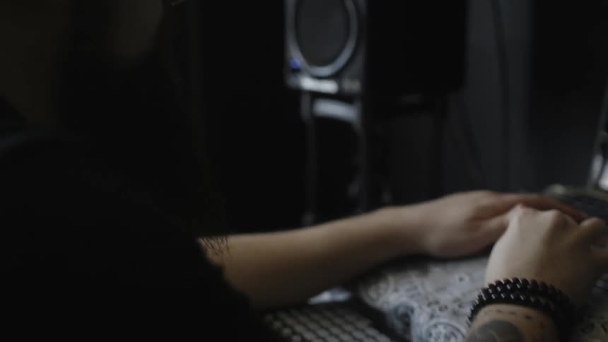 A man is using a computer in a dark room
