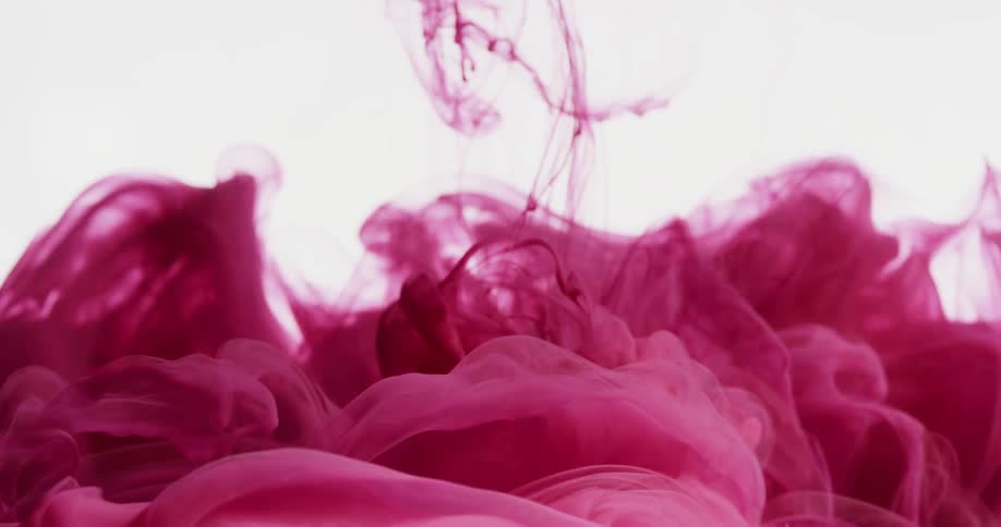 Cloud of magenta ink flowing on a white background