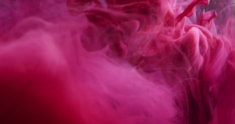 Abstract pink ink fluid falling in slow motion