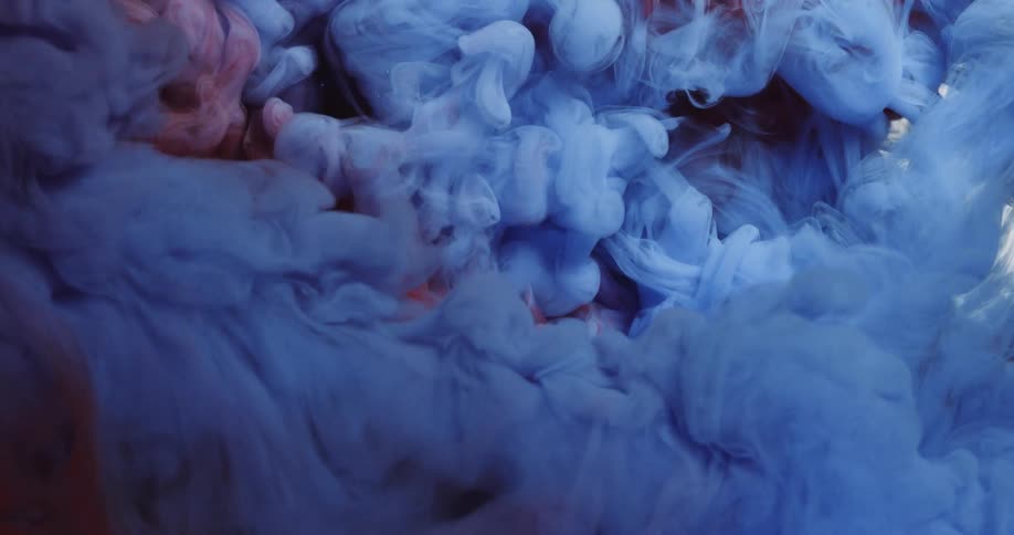Abstract red and blue liquids form clouds and mingle