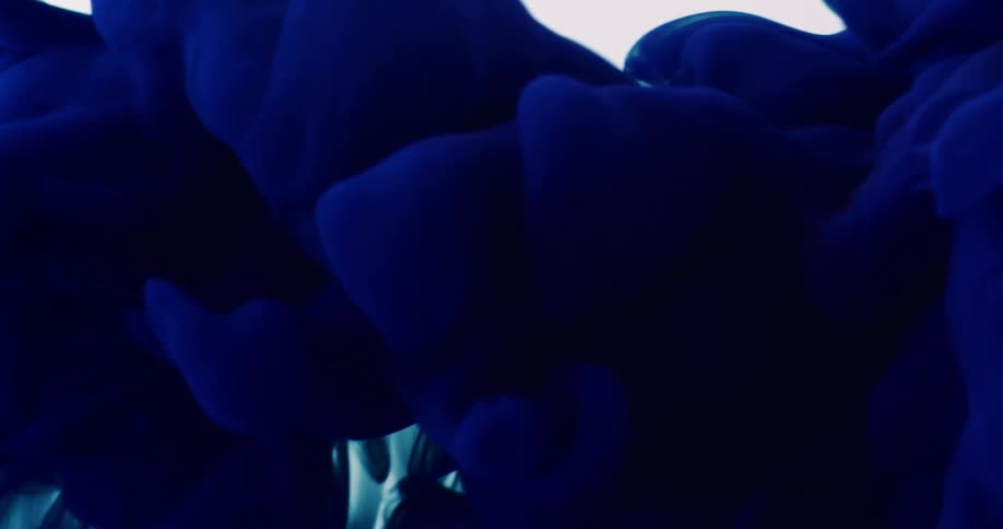 Cloud of blue ink flows up on a white background