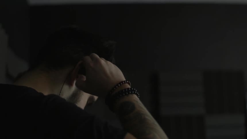 A man puts on earbuds