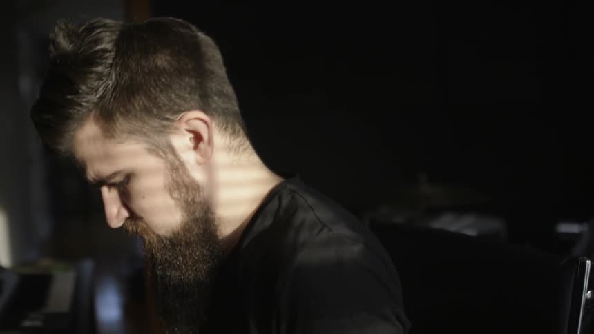 A man is looking down bobbing his head