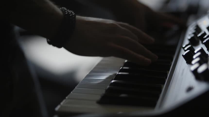 A man is playing the keyboard