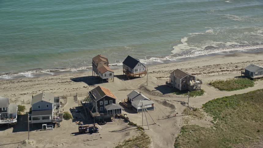 Aerial view of row of houses on ocean coastline