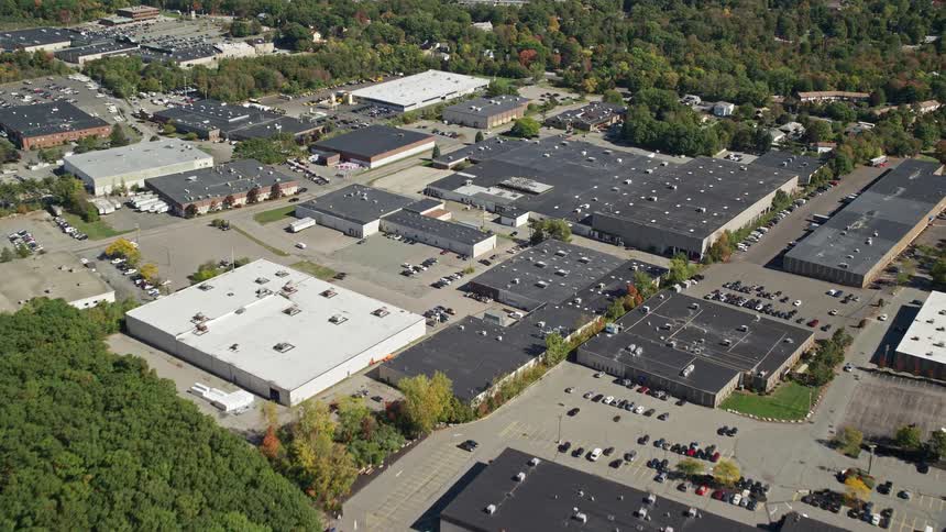 Woods surround commercial complex near residential neighborhood