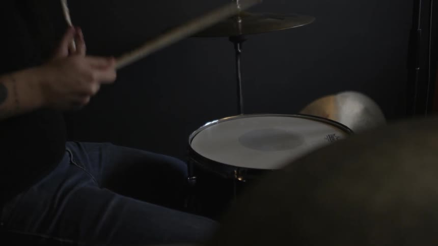 A man is playing the drums fast