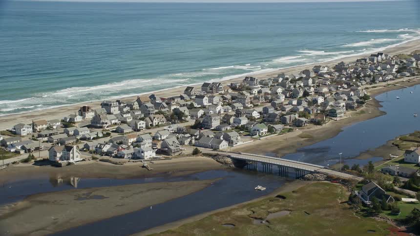 Aerial of residential neighborhoods bordering river and the coast