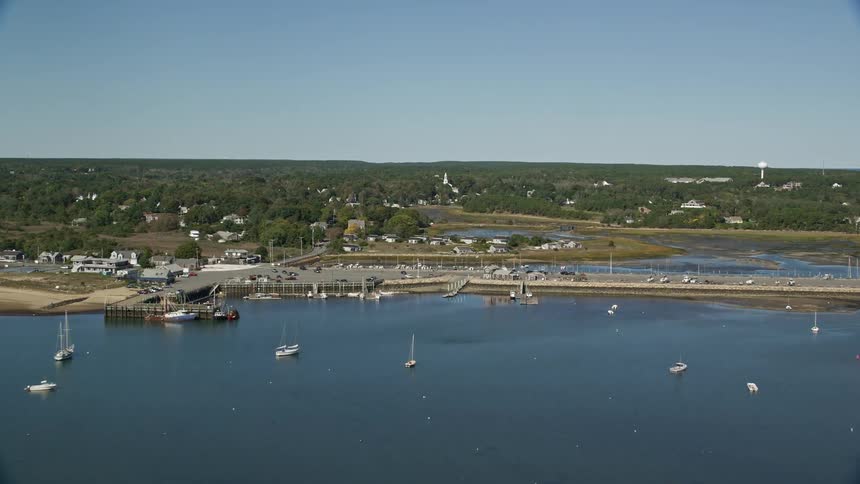 Aerial view of boats on a lake next to a coastal town