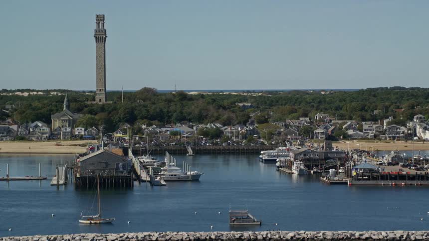Boats are docked in the harbor on a sunny day