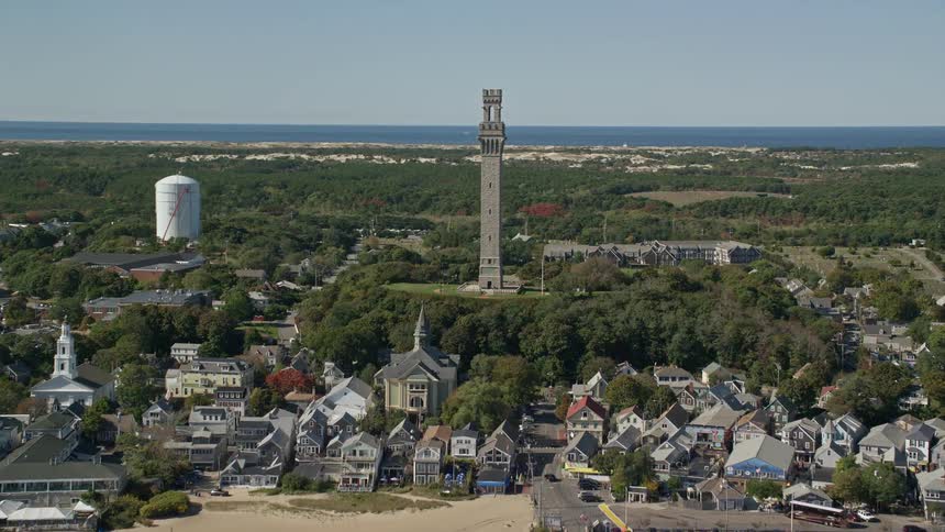 A large tower is in the middle of the coastal town