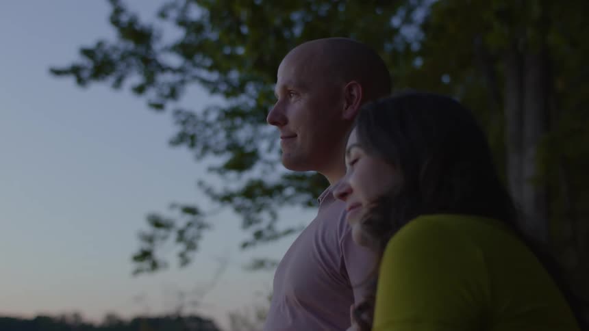 A Husband and Wife enjoying the sunset lakeside