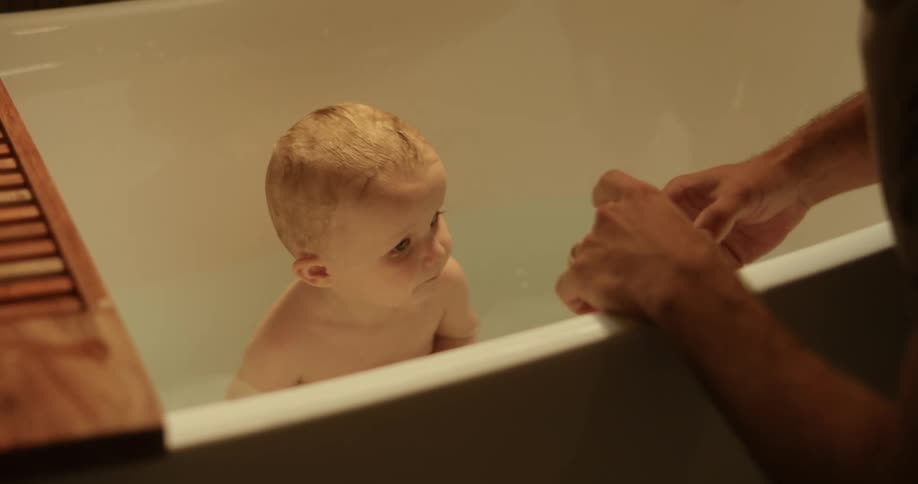 Father bathing his son in the bathtub