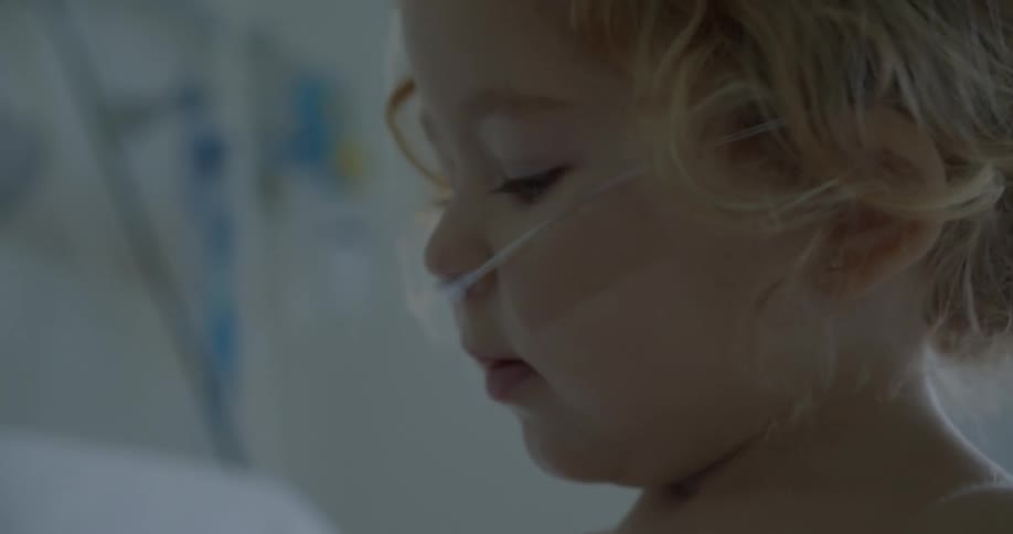 A little blonde girl with a nasal catheter