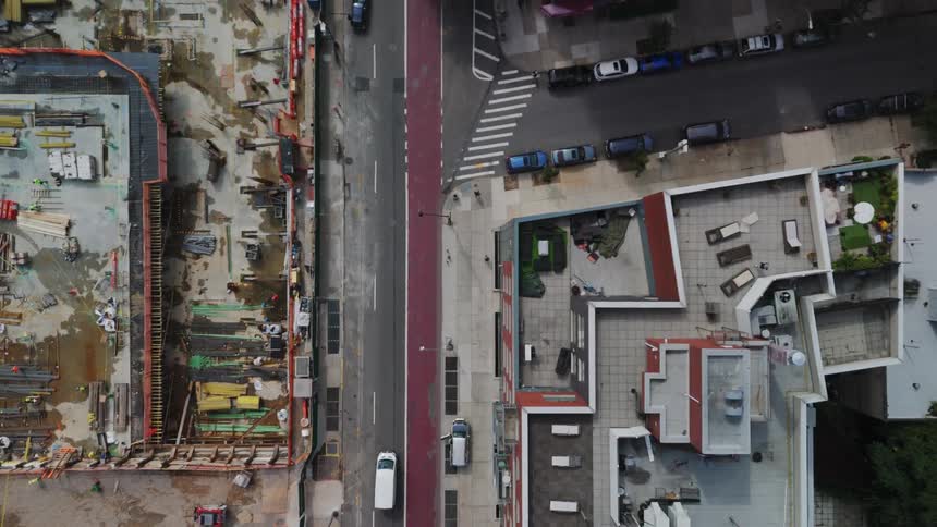 A view from above of residential buildings and a street with some cars passing by