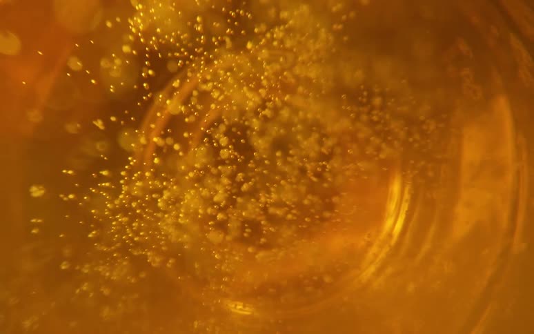 Abstract liquid with bubbles inside a glass