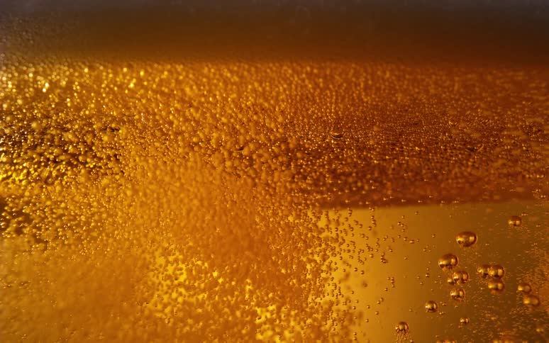 Air bubbles in beer floating upwards