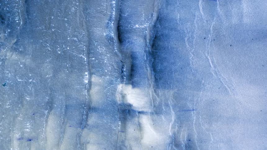 Abstract texture created with blue fluid paint