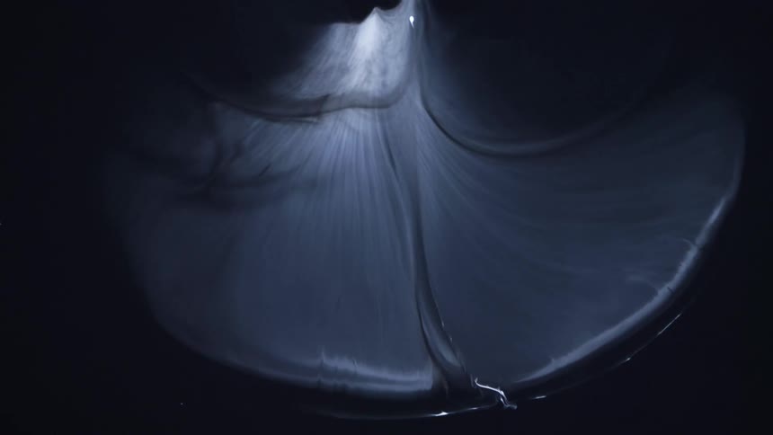 Bubble expands against black with translucent gases inside