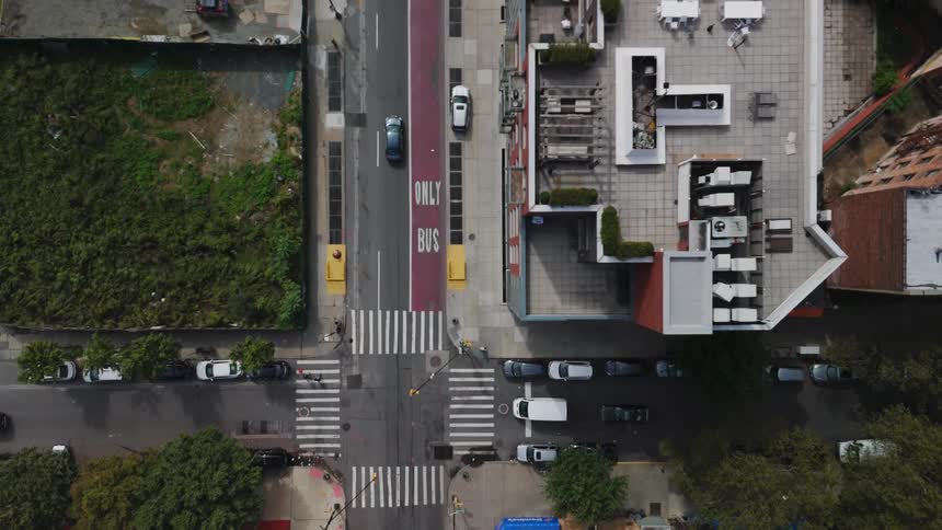 An aerial view of a city with buses and cars moving on the streets