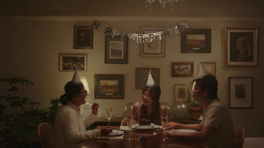 Friends celebrate by eating cake and talking