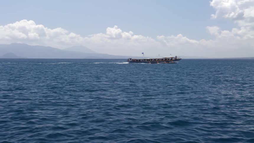 A boat is traveling in the rough waters ahead