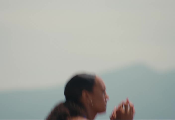 A woman repeatedly performs a squat exercise while outdoors