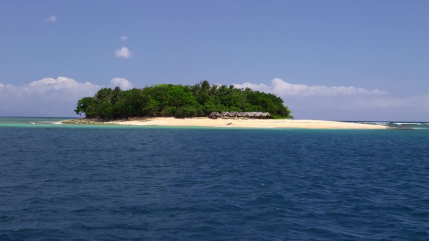 Small island sitting in open blue waters
