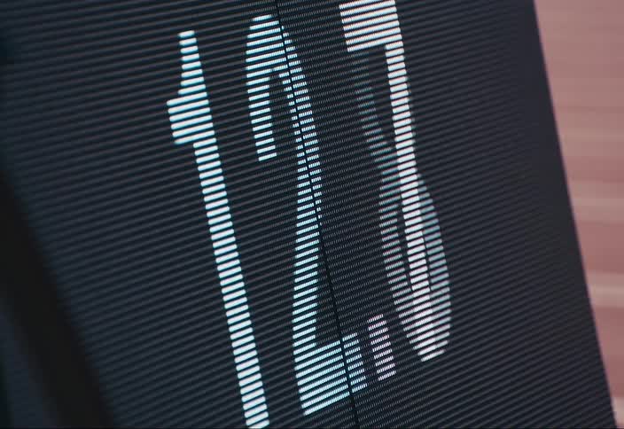 A scoreboard situated near the running tracks displaying the current times