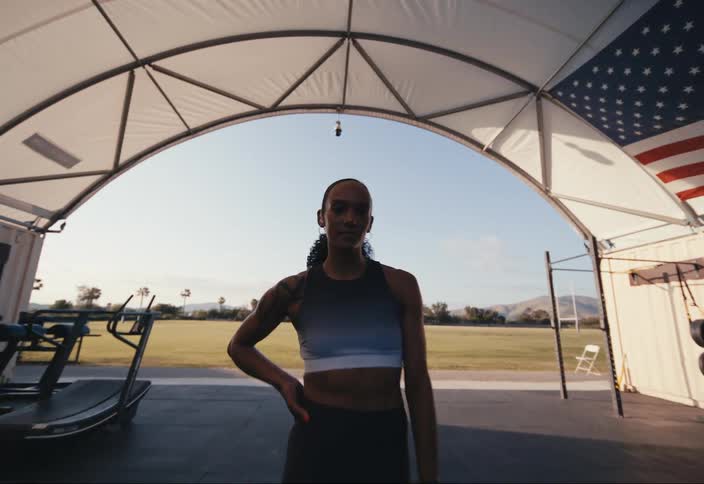 A woman is standing in the gym