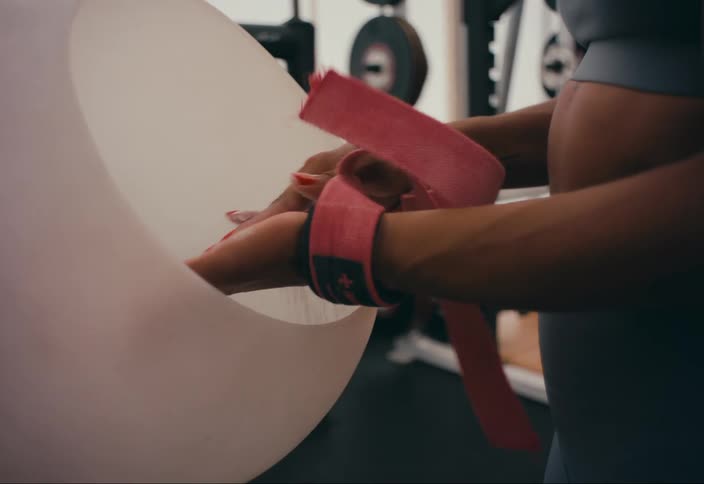 A woman using gym chalk during a workout