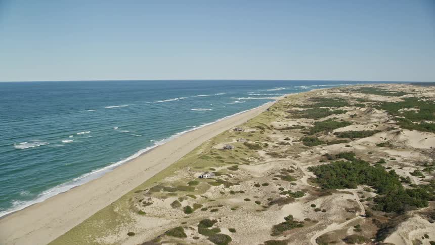 A sandy beach facing the blue ocean