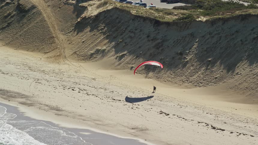 Aerial panorama of a beach with one person particularly with flight equipment