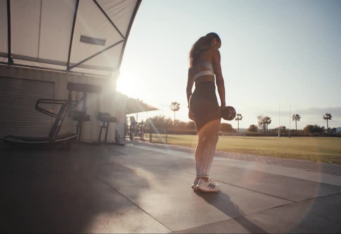 A woman working out at the gym in the afternoon