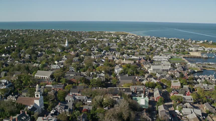 Houses crowd coastal town with multiple churches