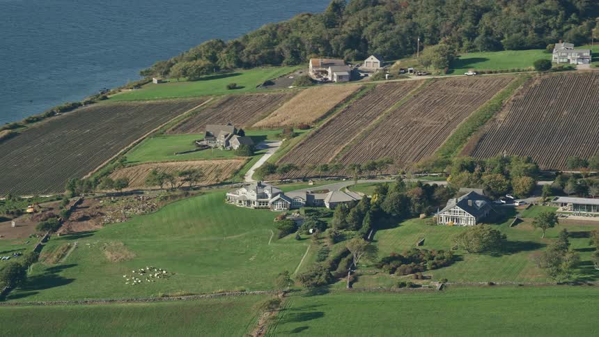 Aerial view of a farm with fields houses and sheep in the countryside