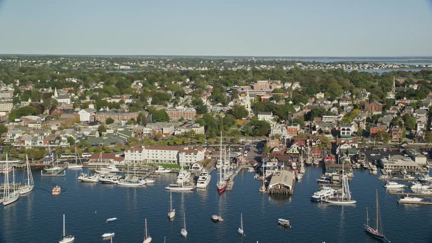 A coastal region of a city facing the sea with several piers and boats