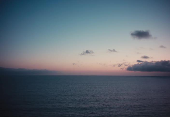 The sun sets over the ocean