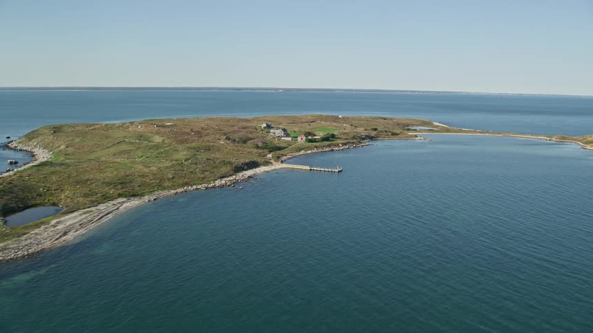 Some isolated houses on a large island in the middle of the ocean