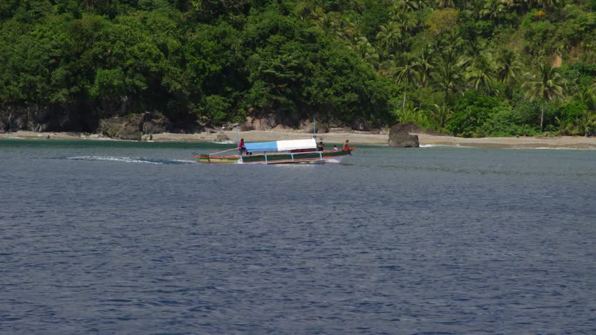 People on a boat float across the water