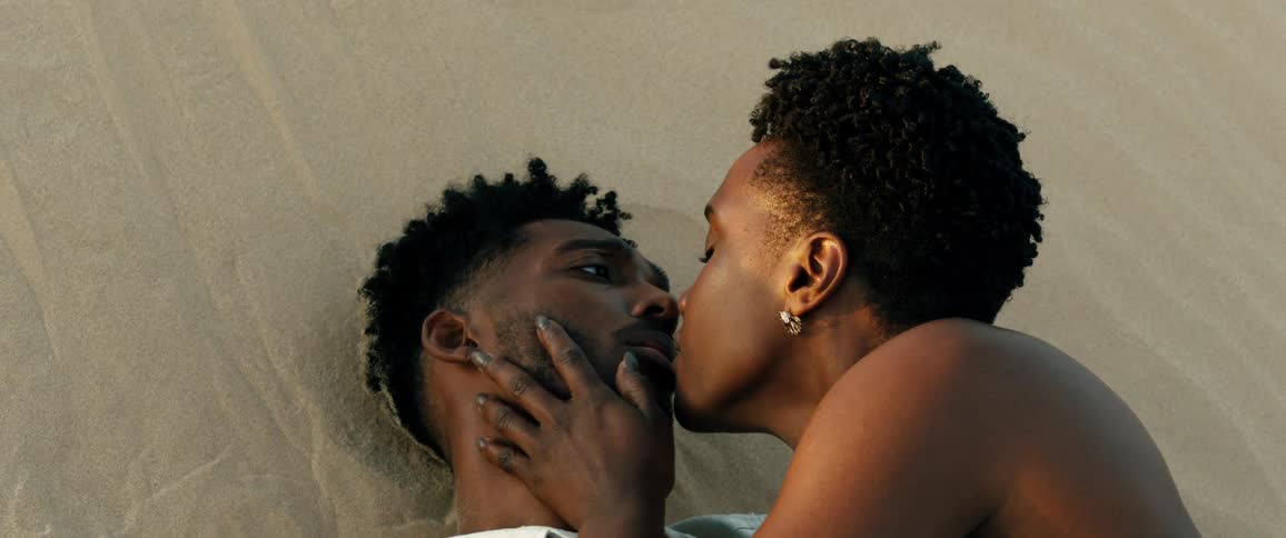 A woman kisses a man